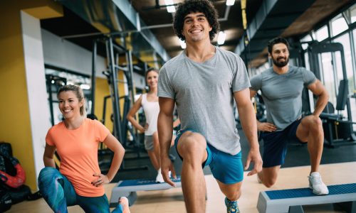 Picture of young cheerful fitness team in gym